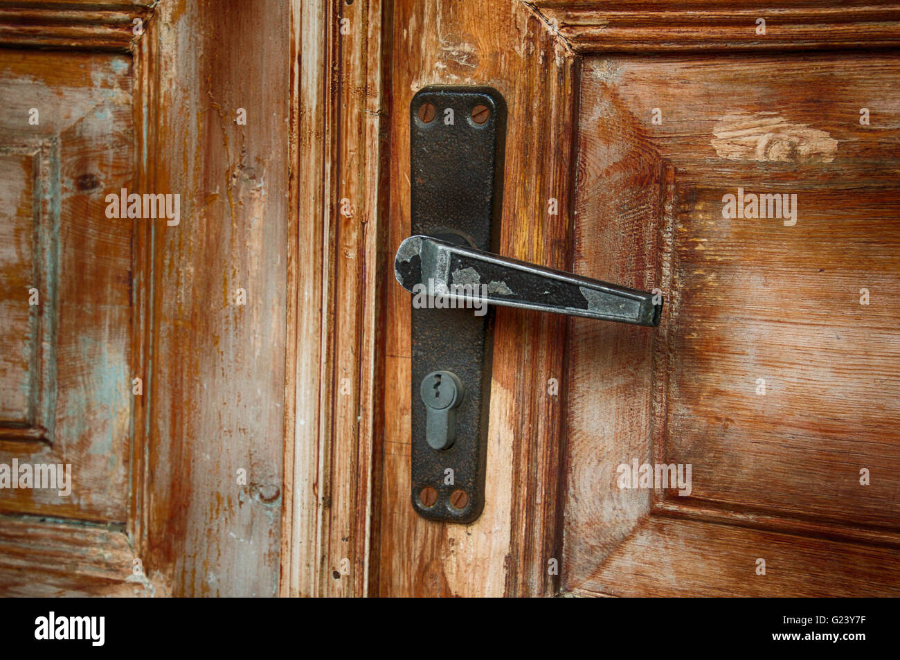 fragment of old door with a keyhole and door handle Stock Photo