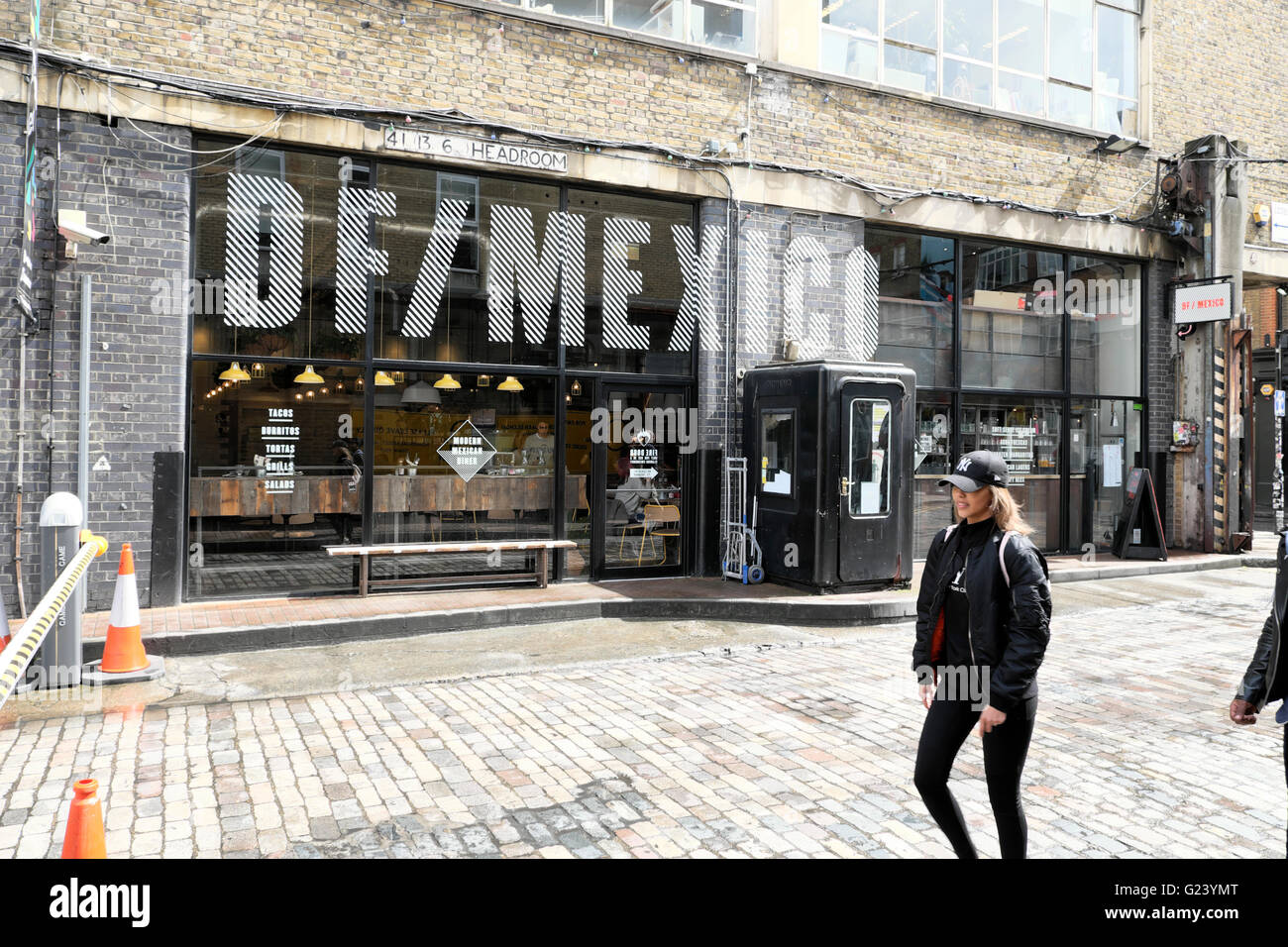 Person walking past DF/Mexico Mexican restaurant on Dray Walk and Hanbury Street near Brick Lane in East London UK  KATHY DEWITT Stock Photo