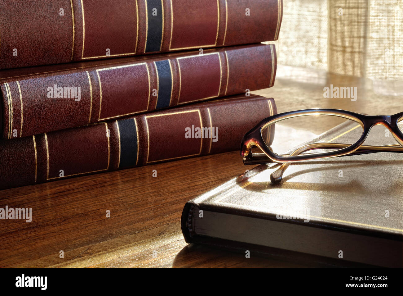 books on the table and glasses and the bottom window and curtains Stock Photo