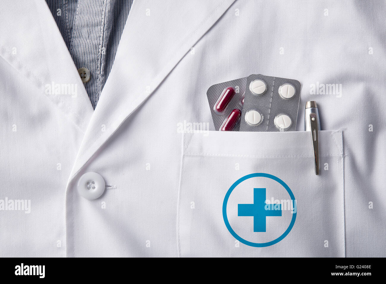 Close up white gown doctor with pills blisters and pen in pocket. Horizontal composition. Front view Stock Photo