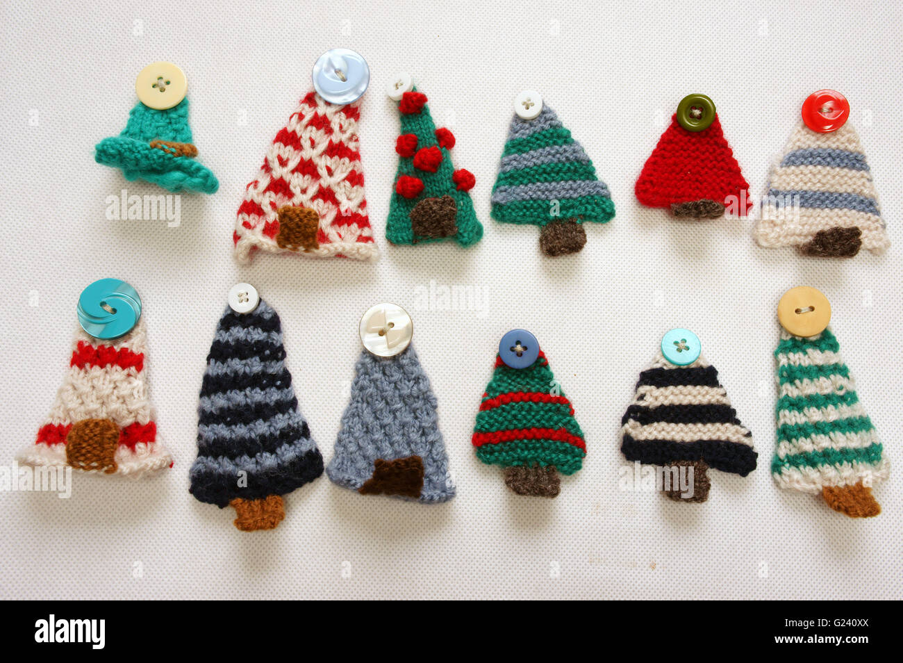 Handmade product for winter holiday, group of knitting ornament as leaf, acorn, clock, mushroom, strawberry, pine tree, hat Stock Photo