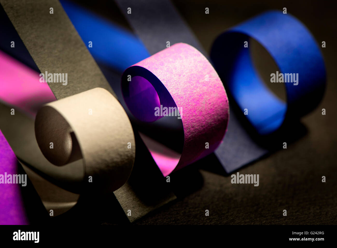 Colourful strips of cardboard as texture and background on black background Stock Photo