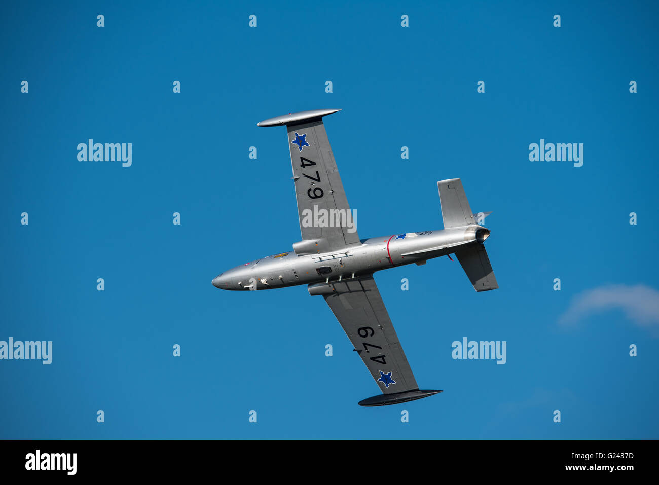 Silver jet doing a display at the Lowveld Airshow Stock Photo