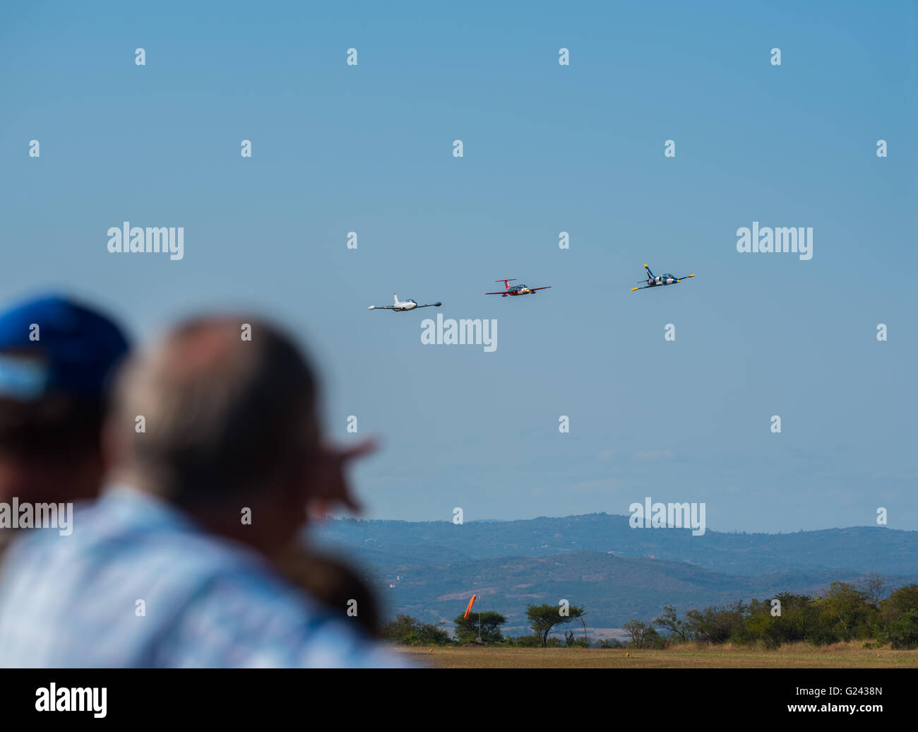 A spectator pointing at the approaching jets at the Lowveld Airshow Stock Photo