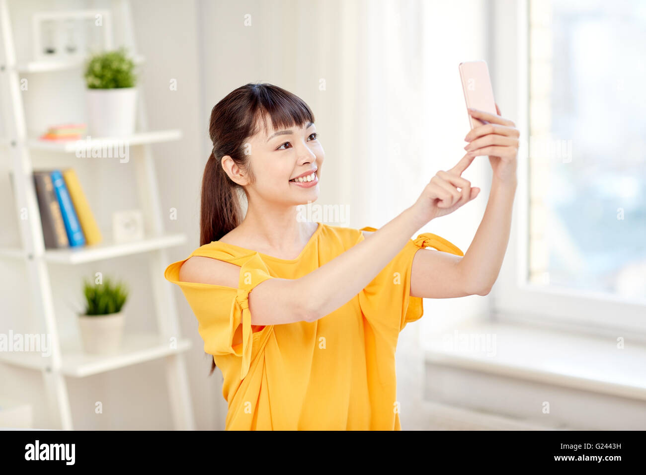 happy asian woman taking selfie with smartphone Stock Photo - Alamy