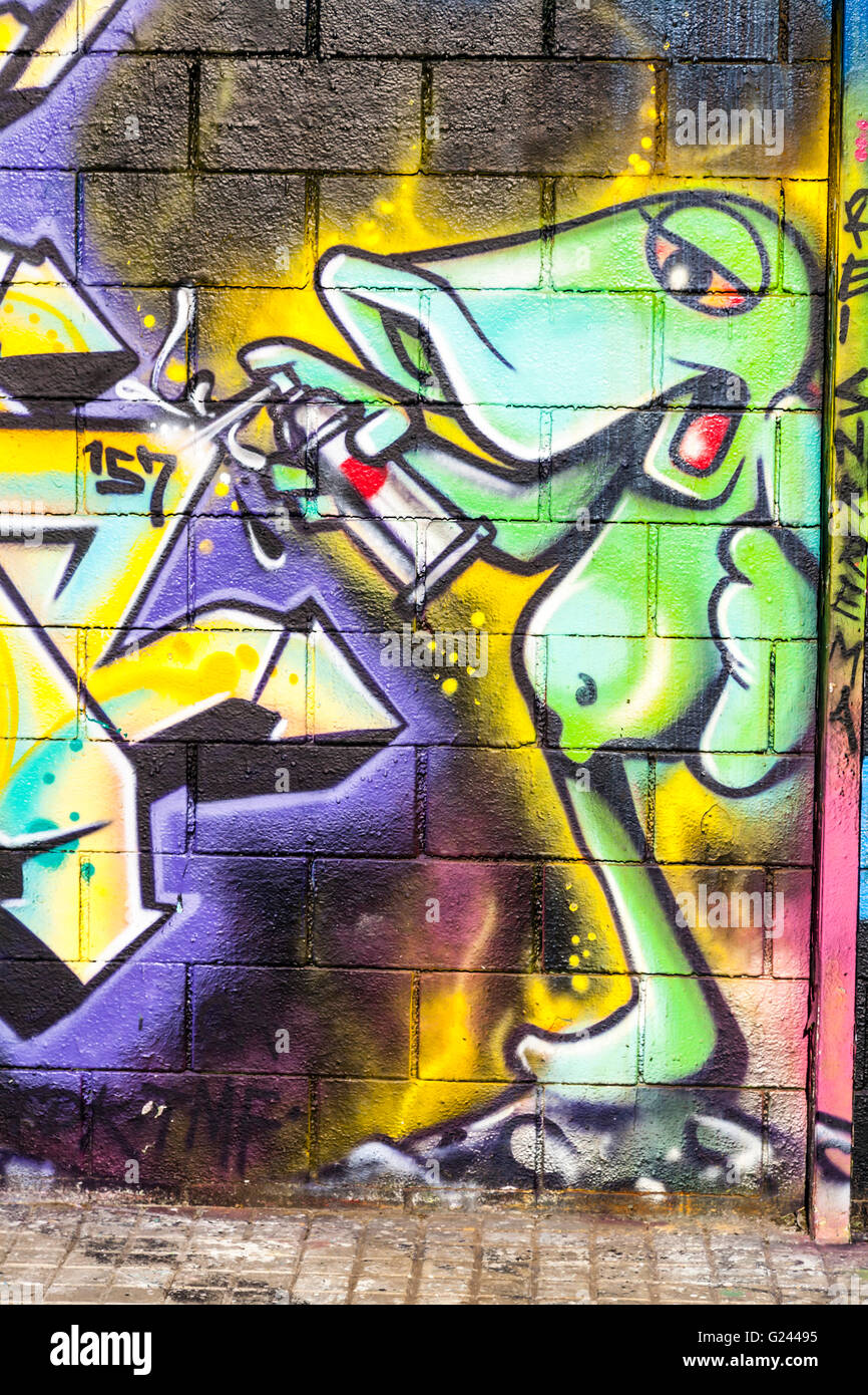 Detail of A Green Cartoon Creature Spraying graffiti on a wall, Barcelona, Catalonia, Spain. Stock Photo