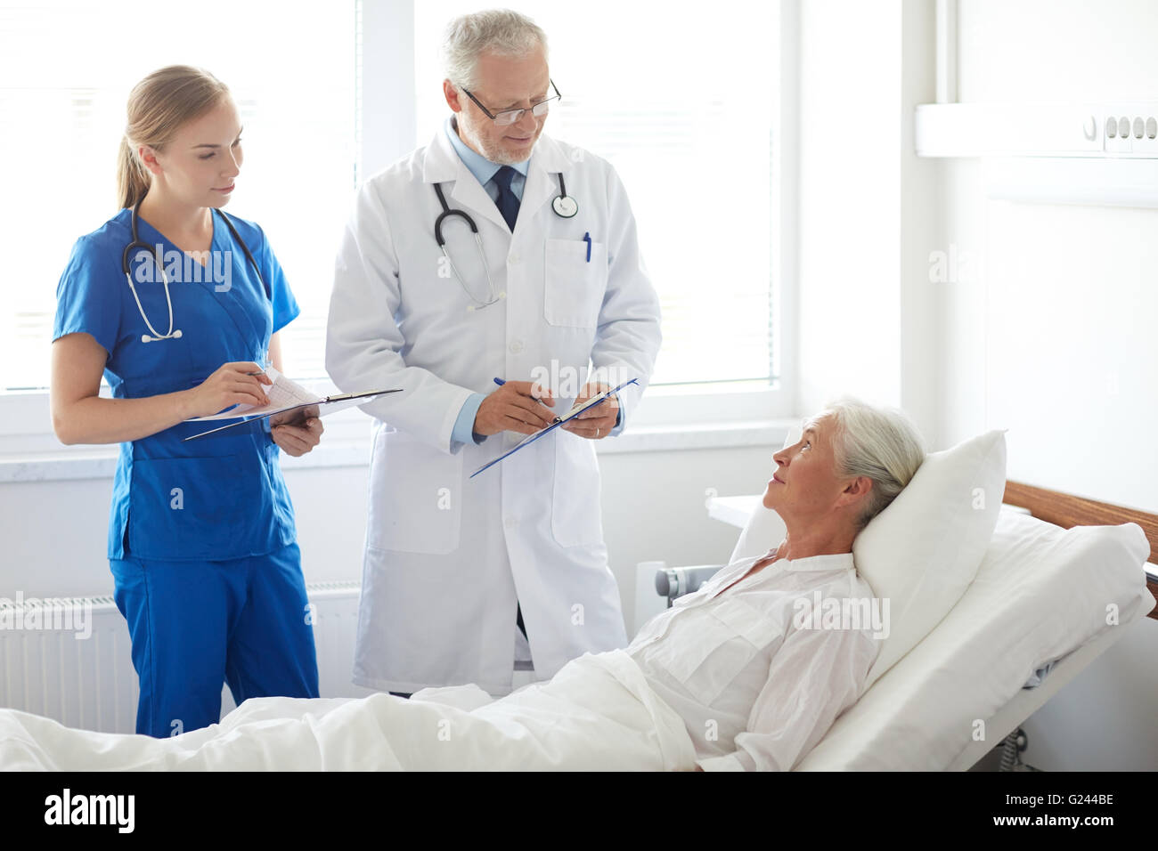 doctor and nurse visiting senior woman at hospital Stock Photo - Alamy