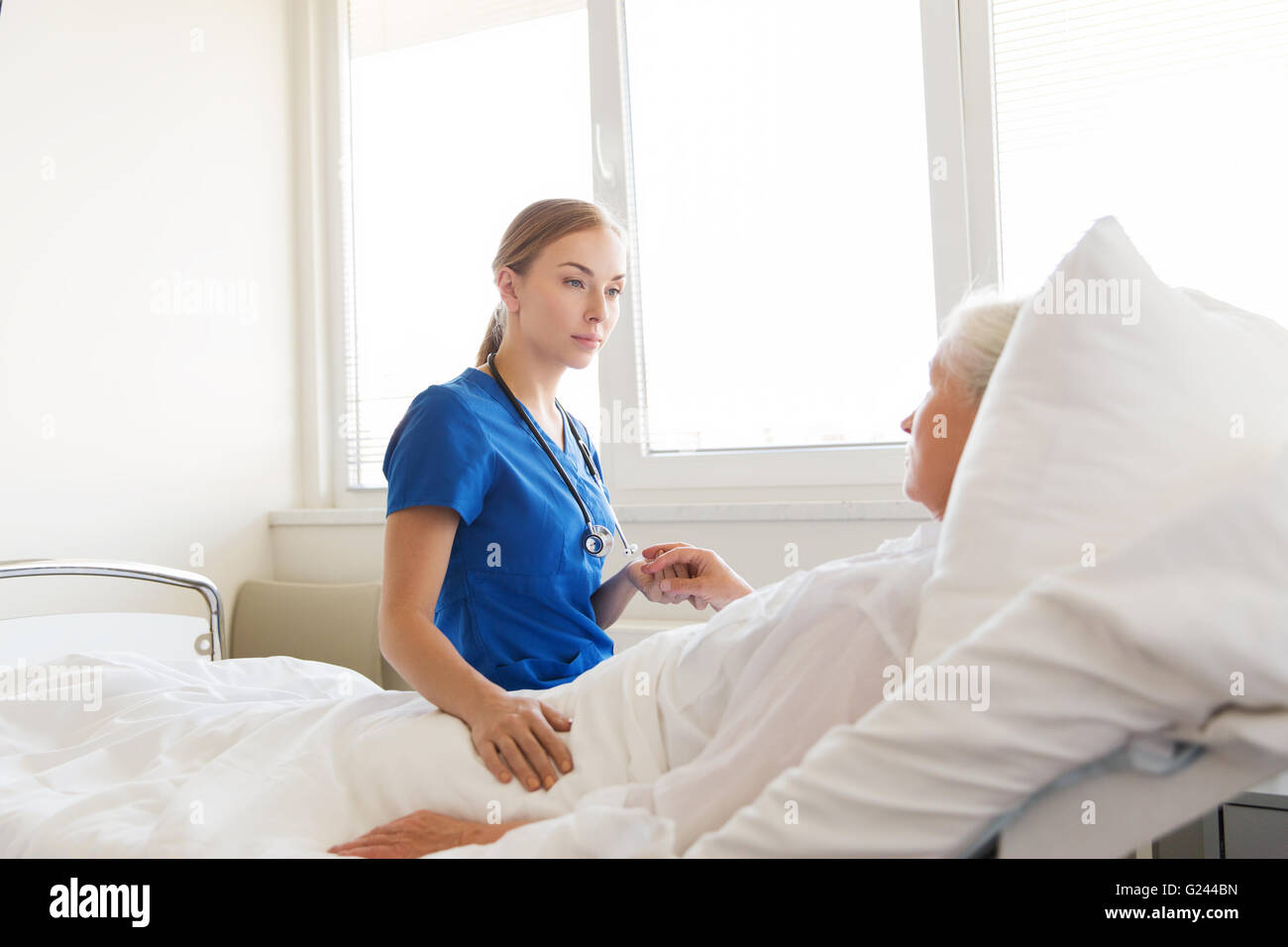 doctor or nurse visiting senior woman at hospital Stock Photo - Alamy