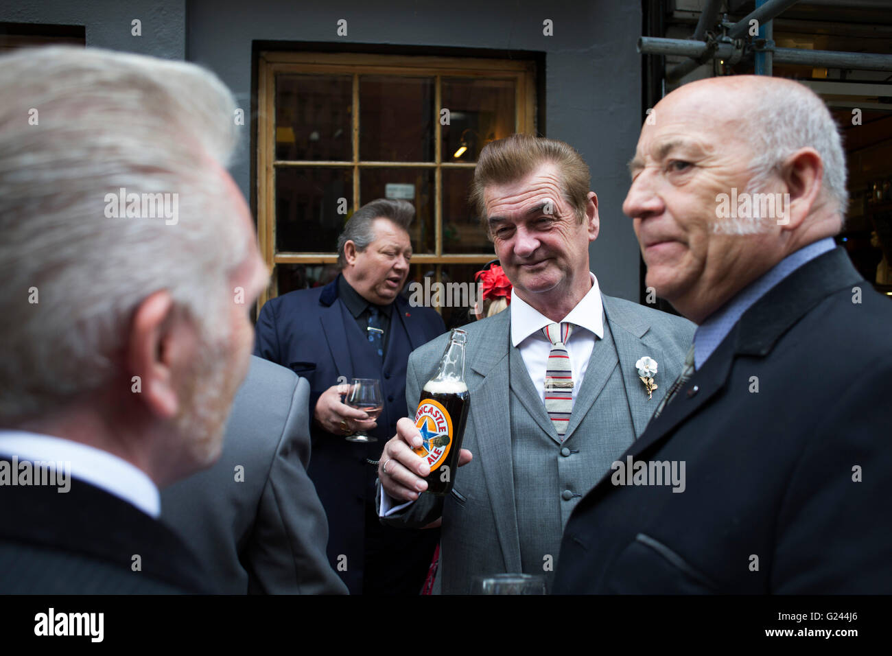 Teddy Boys gather outside a pub in Soho following a 40th anniversary of their infamous march on the BBC to protest that they wanted more rock and roll on the radio, which they recreated today on May 14th 2016 in London, United Kingdom. Teddy Boy, also known as Ted, is a British subculture typified by men wearing clothes that were partly inspired by the styles worn by dandies in the Edwardian period, which tailors had attempted to re-introduce in Britain after World War II. It is sometimes inaccurately written that the Teddy Boy style and phenomenon appeared in Britain during the mid 1950s as a Stock Photo