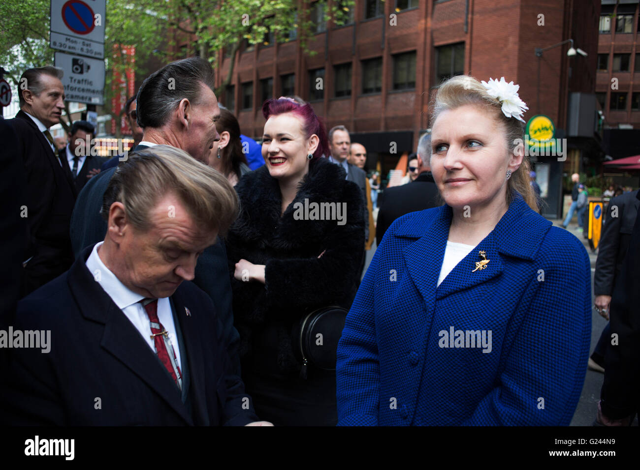 Teddy Boys gather outside a pub in Soho following a 40th anniversary of their infamous march on the BBC to protest that they wanted more rock and roll on the radio, which they recreated today on May 14th 2016 in London, United Kingdom. Teddy Boy, also known as Ted, is a British subculture typified by men wearing clothes that were partly inspired by the styles worn by dandies in the Edwardian period, which tailors had attempted to re-introduce in Britain after World War II. It is sometimes inaccurately written that the Teddy Boy style and phenomenon appeared in Britain during the mid 1950s as a Stock Photo