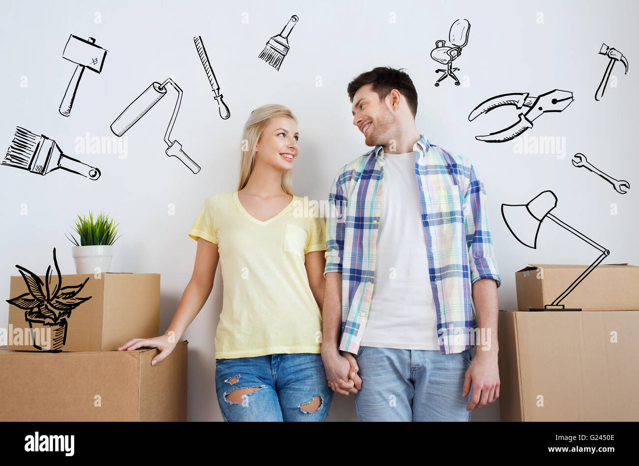 smiling couple with big boxes moving to new home Stock Photo - Alamy