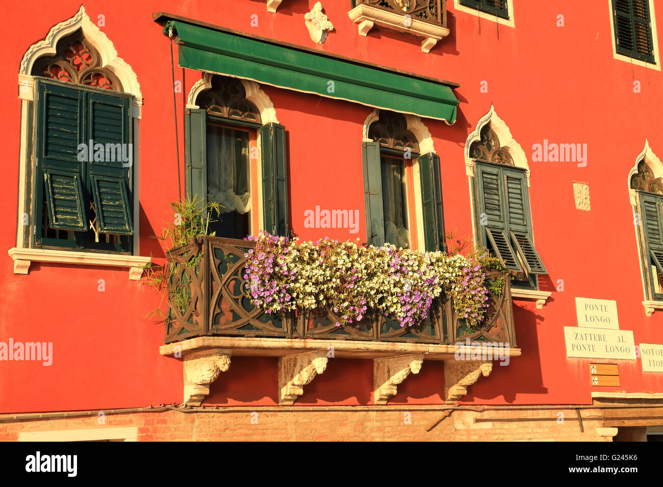 Palazzo window and balcony with flowers, Venice Stock Photo