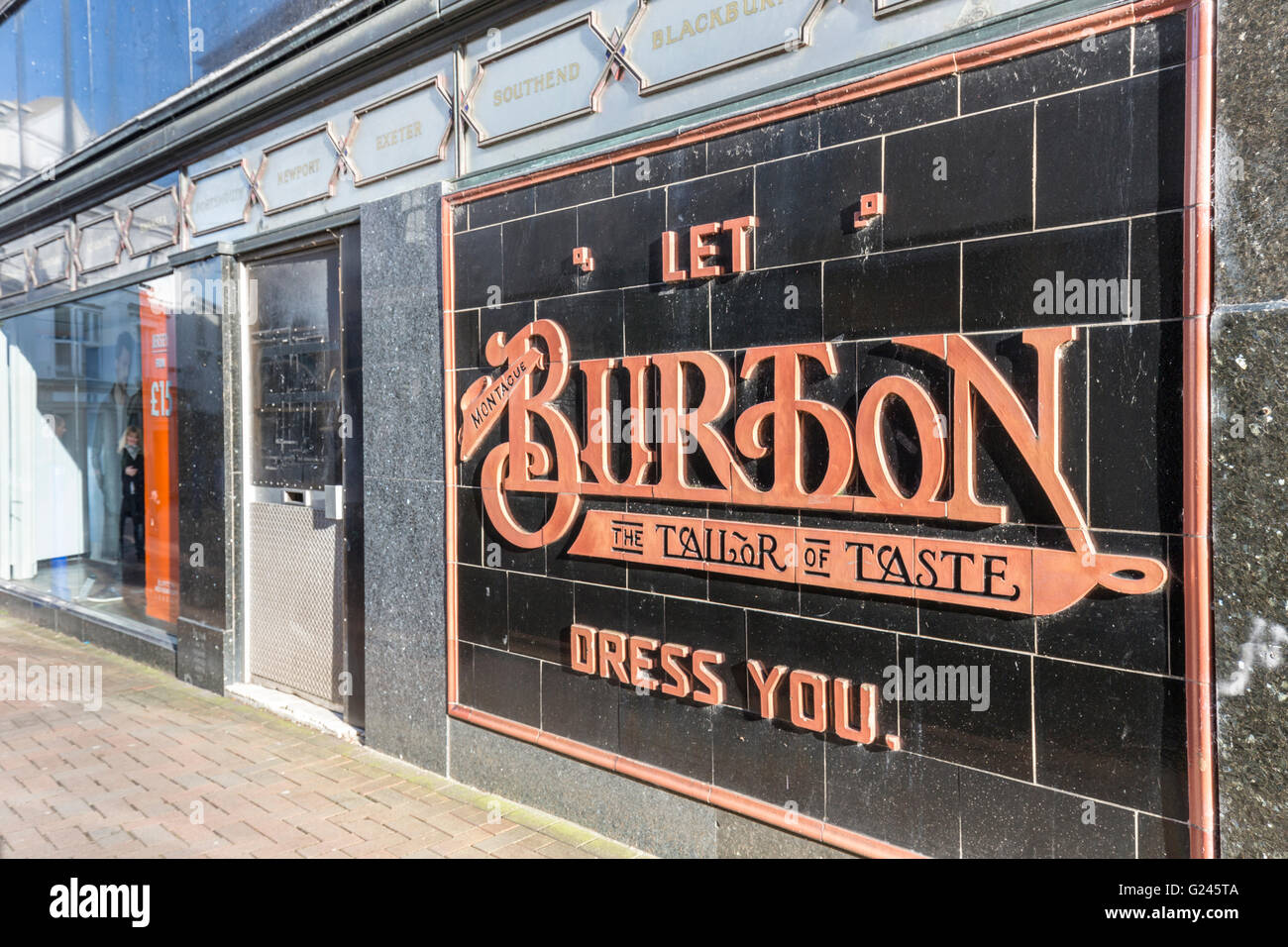 Old Burton tailor sign in tiles on side of shop, Abergavenny, Wales, UK Stock Photo
