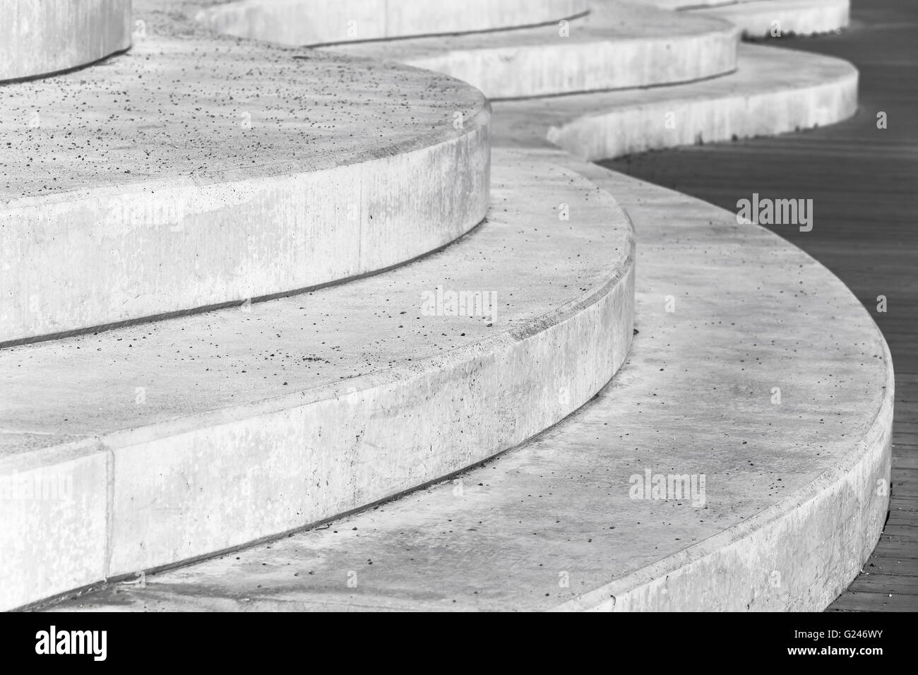 Abstract concrete interior fragment, curved stairs. Photo with selective focus Stock Photo