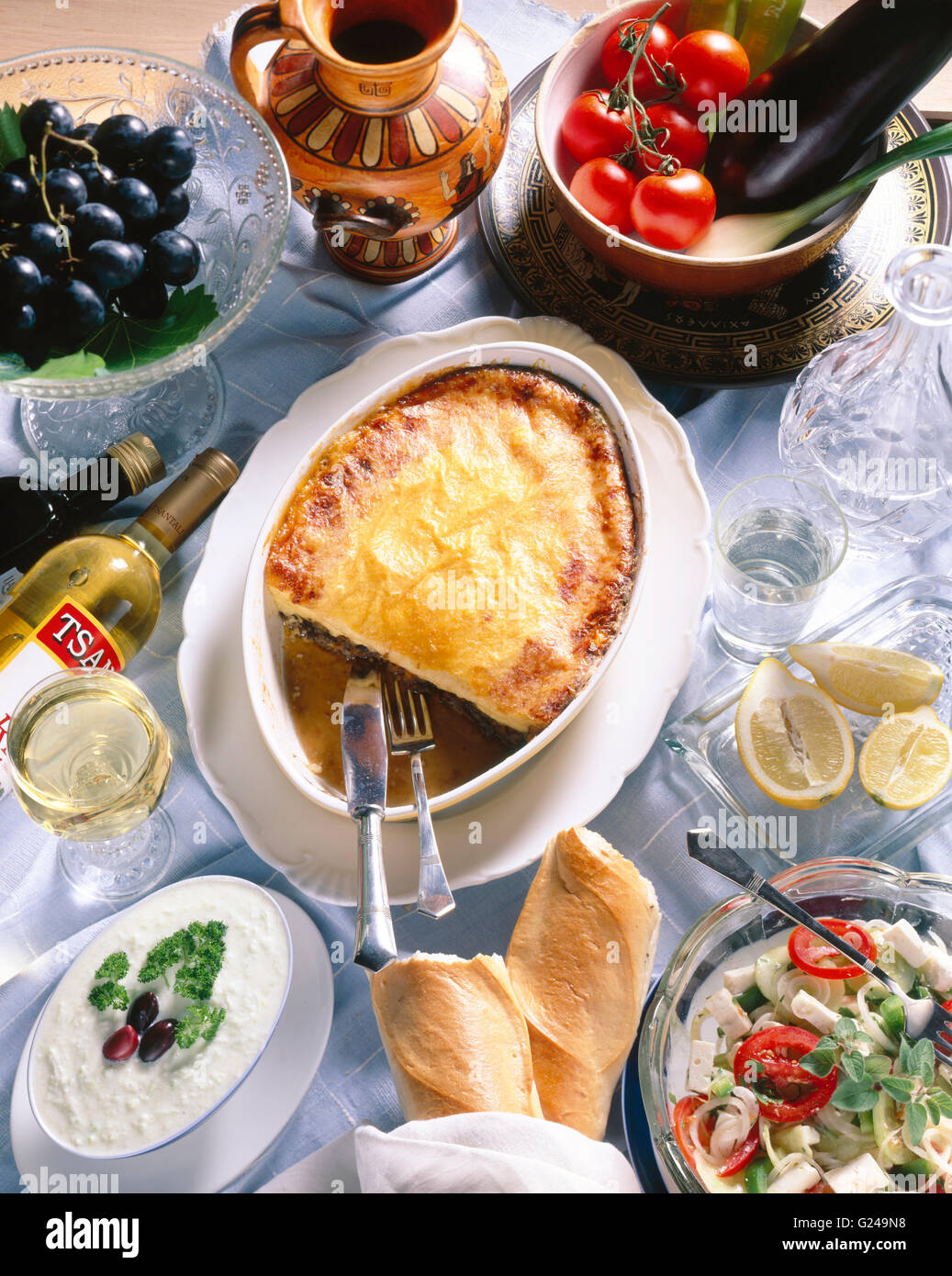 Greek national cuisine, salad with feta cheese, tzatziki, moussaka, Retsina wine Stock Photo