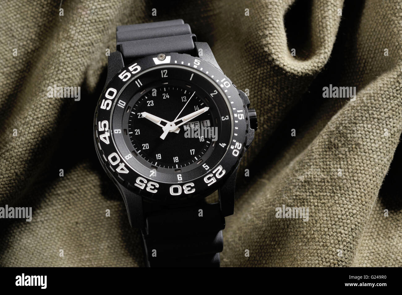 Tritium military watch on camouflage cloth Stock Photo