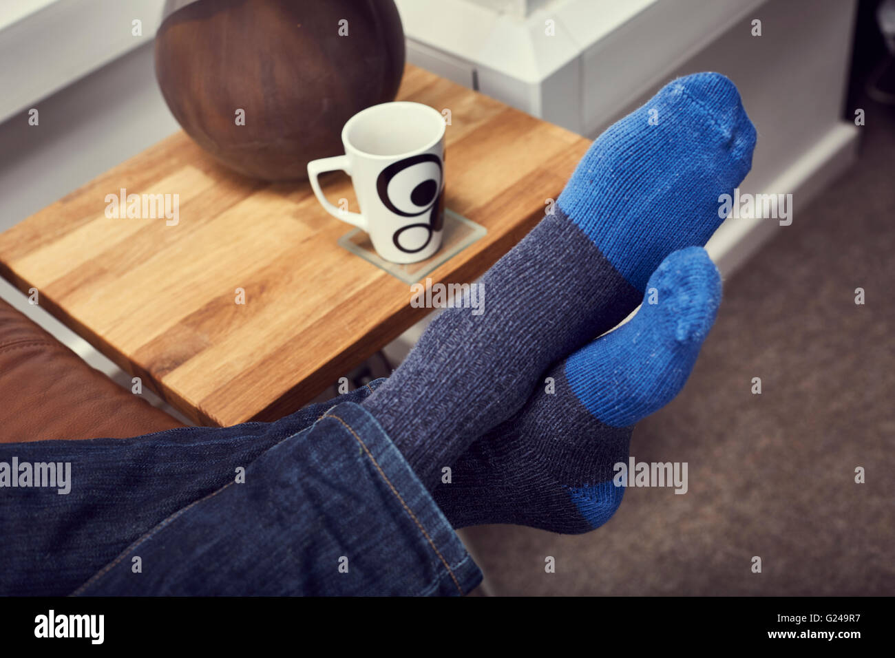 Relaxing on the Sofa with Coffee and Feet Up Stock Photo