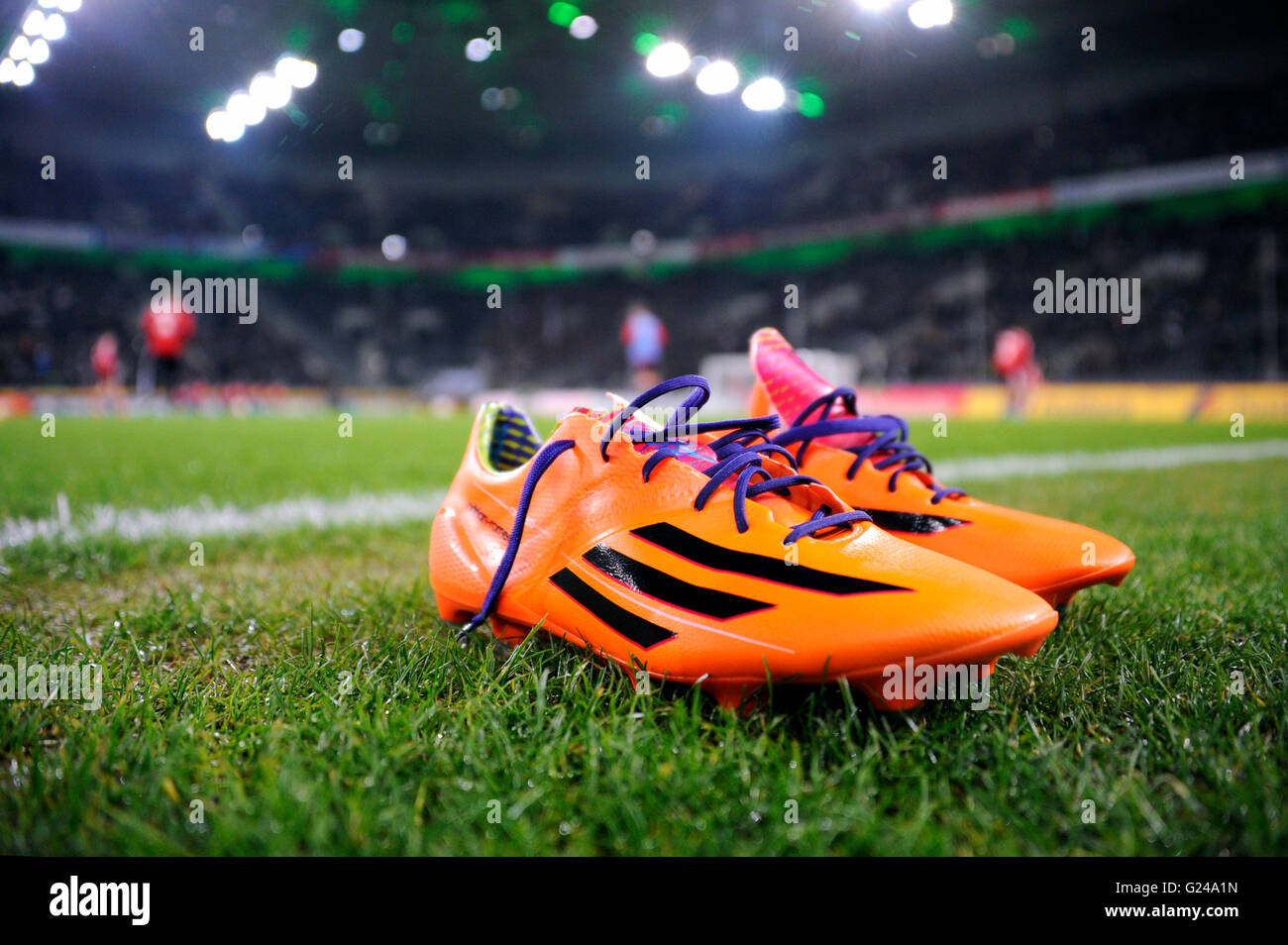 Orange-coloured Adidas football boots on the edge of the pitch,  Borussia-Park, Mönchengladbach, North Rhine-Westphalia, Germany Stock Photo  - Alamy