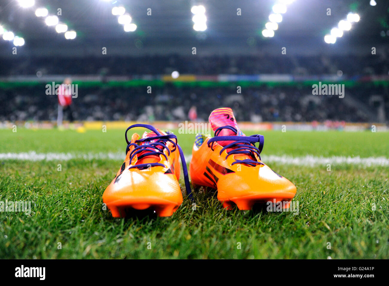 Orange-coloured Adidas football boots on the edge of the pitch, Borussia-Park, Mönchengladbach, North Rhine-Westphalia, Germany Stock Photo