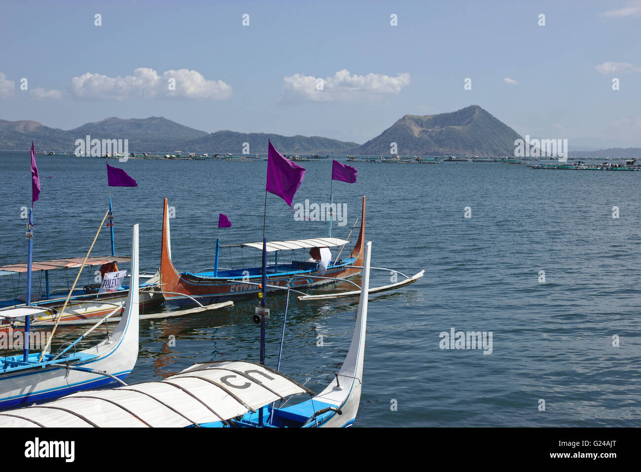 Boats on the shore of Lake Taal, with Volcano Island in the back, Luzon, Philippines Stock Photo