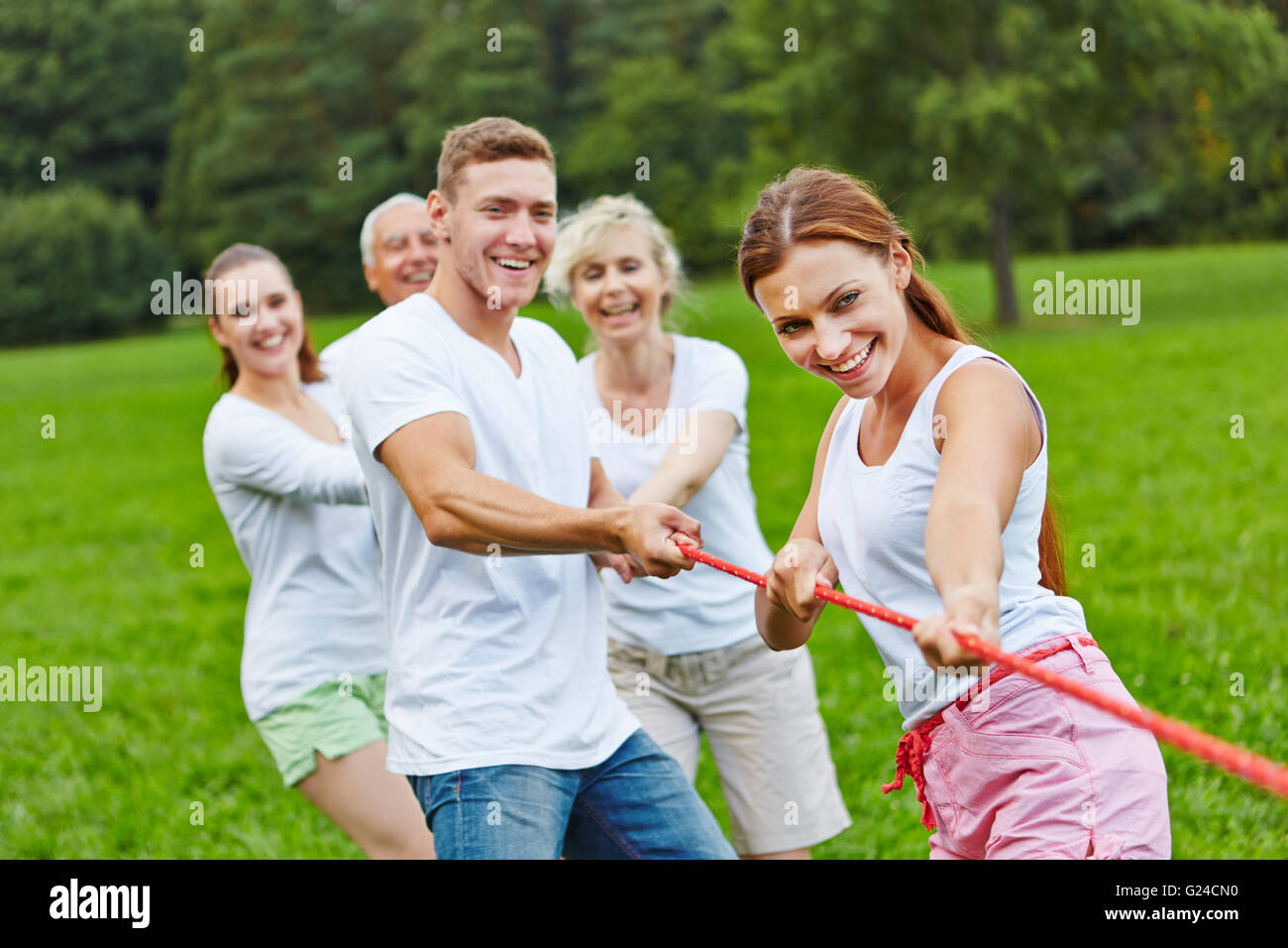 Strong group in a competition playing tug of war Stock Photo