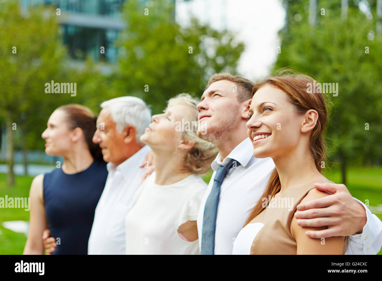 Successful business team standing together outdoors in a row Stock ...