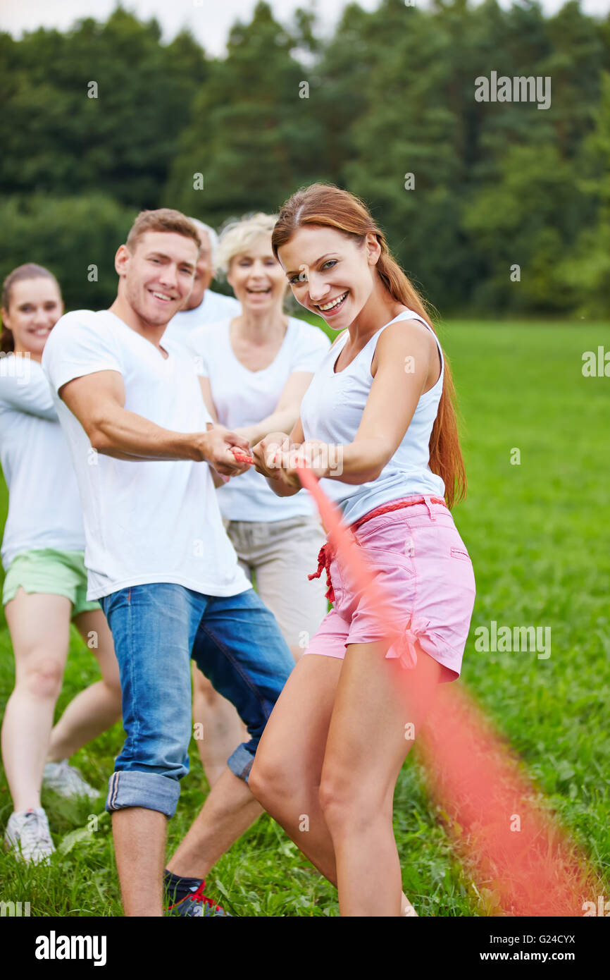 People playing tug of war with rope during a competition outdoors Stock Photo