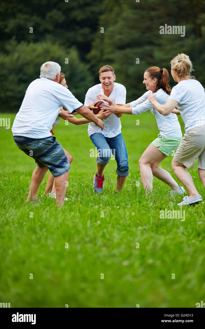 Happy family playing american football in the garden Stock Photo - Alamy