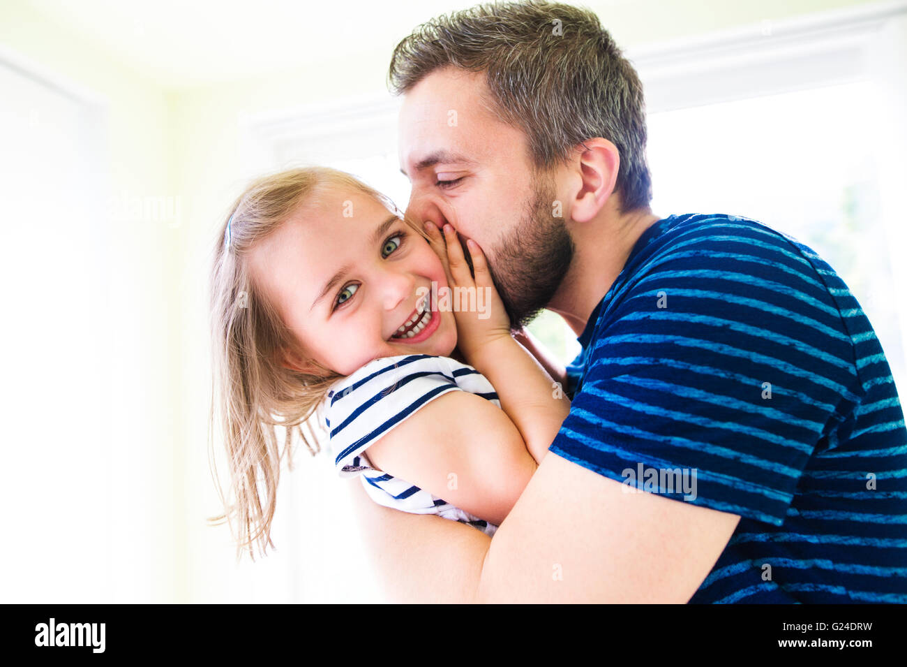 Close up of hipster father kissing his little daughter Stock Photo