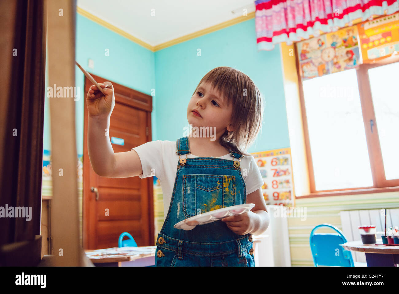The girl draws a painting at the easel Stock Photo - Alamy