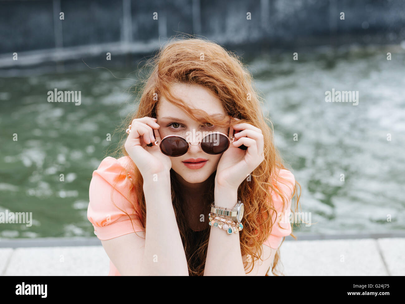 Portrait of a young redhead woman wearing sunglasses Stock Photo - Alamy