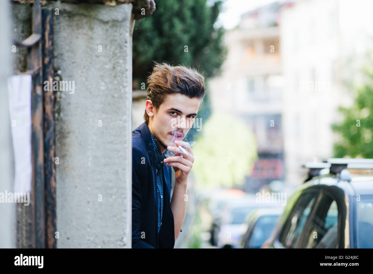 Portrait of a young man smoking Stock Photo