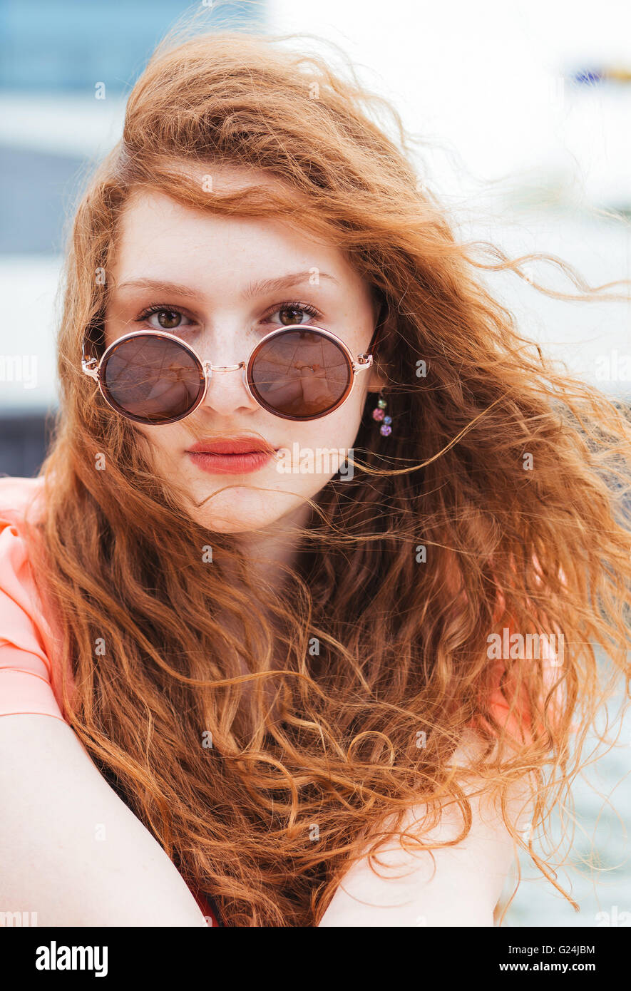 Portrait of a young redhead woman with sunglasses Stock Photo - Alamy