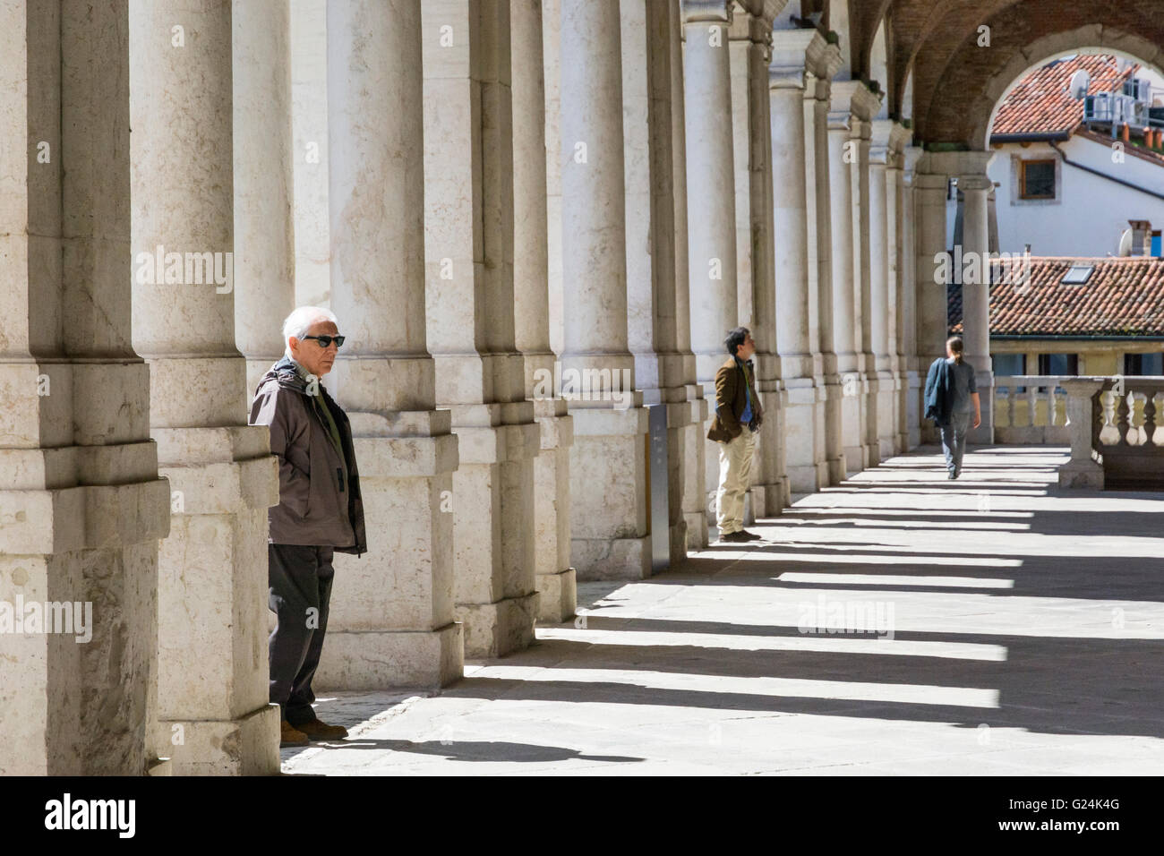 Vicenza,Italy-April 3,2015:people on  the  famous colonnade of the Palladian basilica in the center of Vicenza during a sunny da Stock Photo