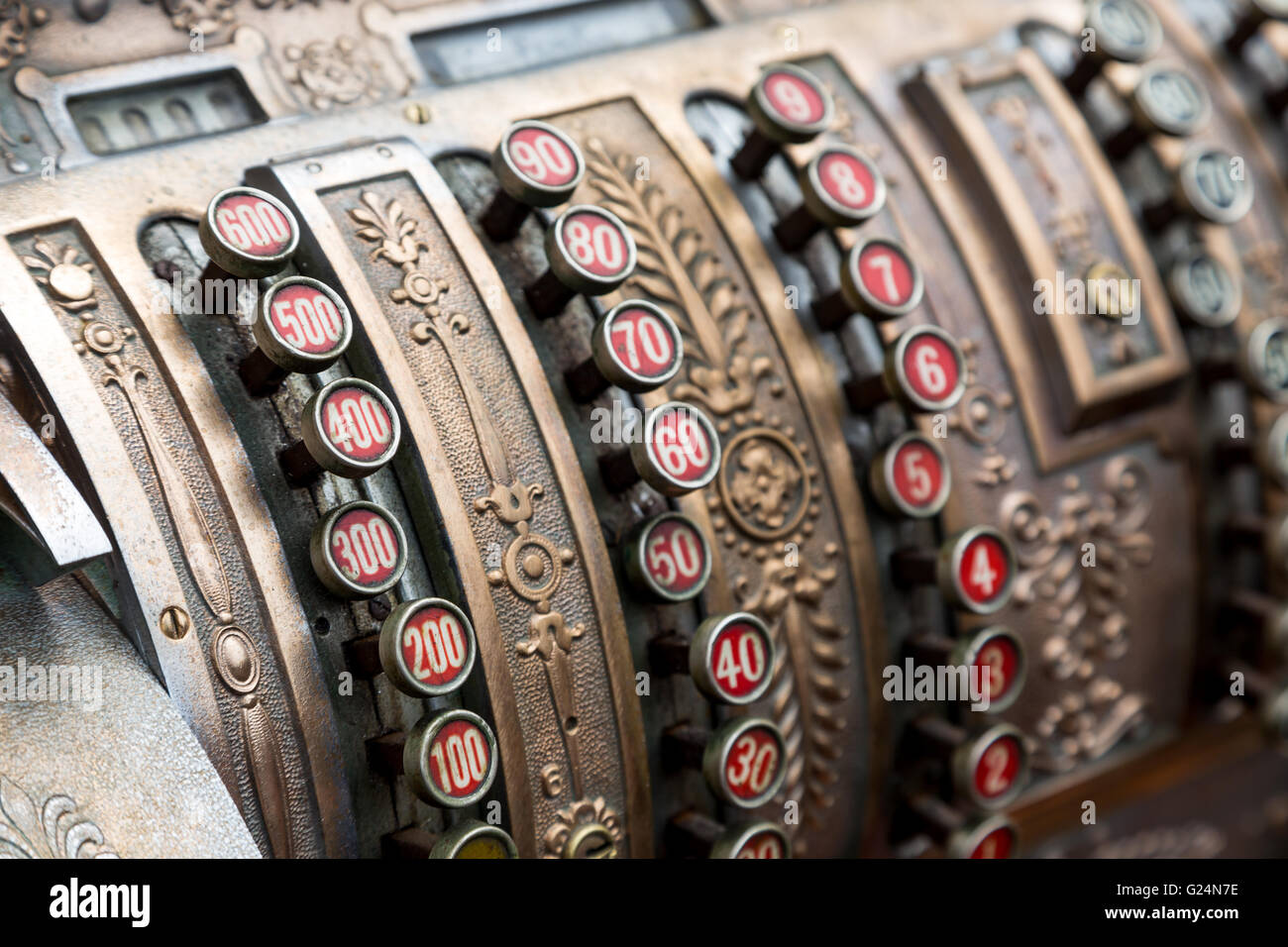 closeup vintage cash register with red round buttons for digits Stock Photo