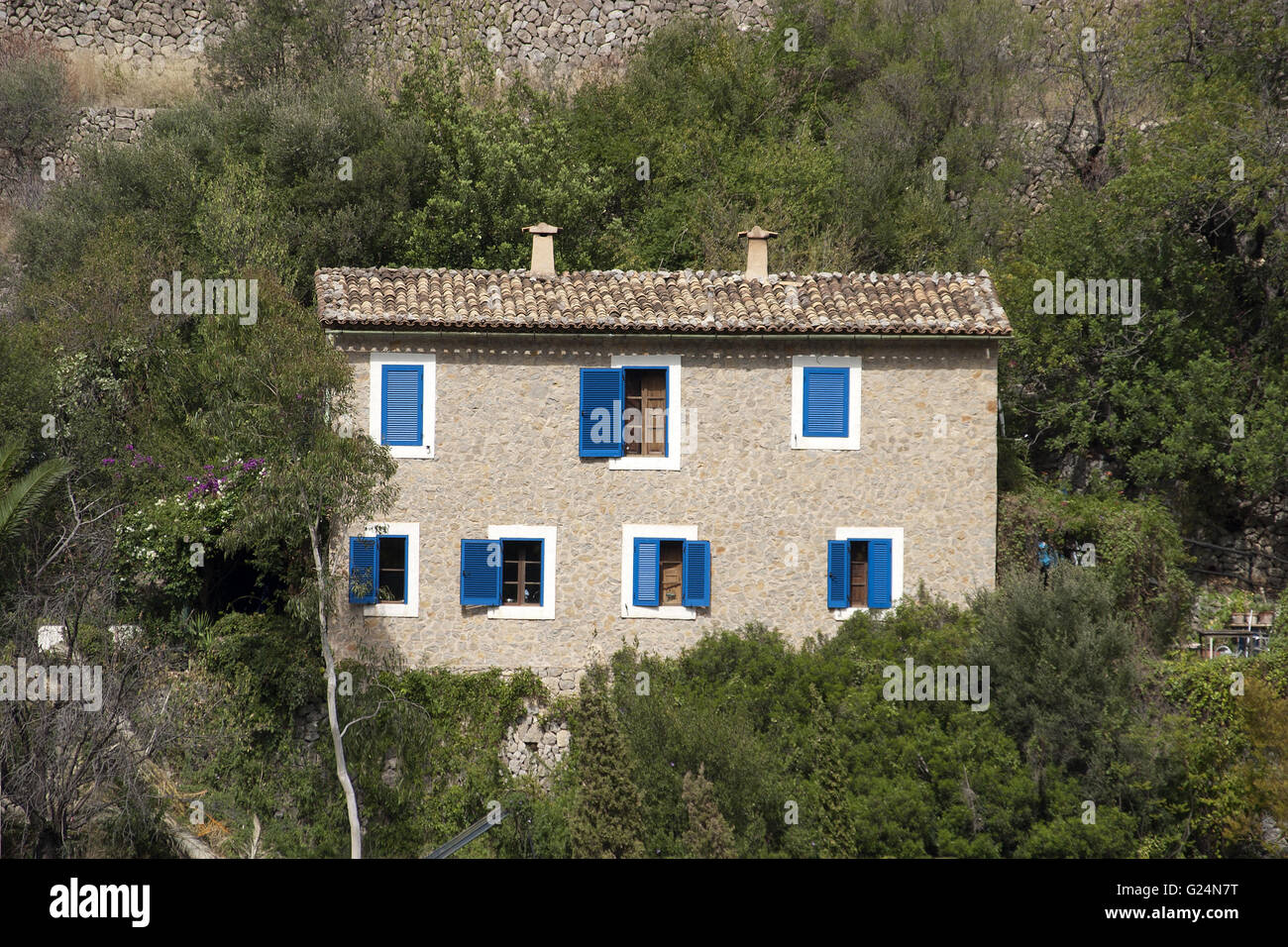a beautiful picturesque head-on picture of a cottage wrapped in green vegetation, in Palma de Mallorca, Spain, seaside, tourism Stock Photo