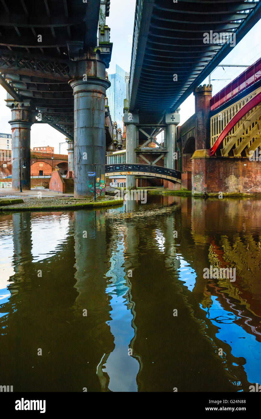 The Beetham Tower appears between bridges in the regeneration area of Castlefield Manchester Stock Photo
