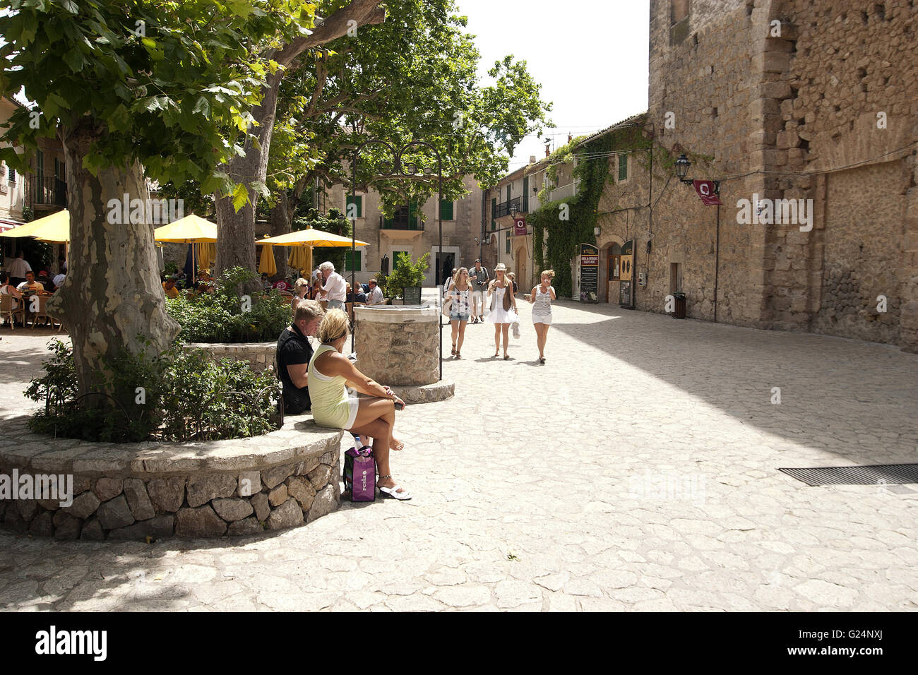 a beautiful wide angle shot of tourists sitting down and passing by in an old town in Palma de Mallorca, Spain, seaside, tourism Stock Photo