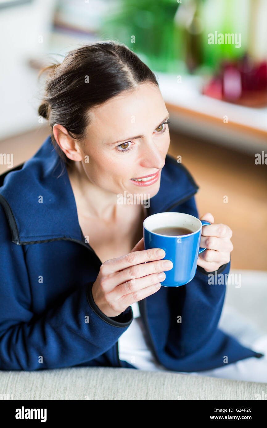 Woman drinking hot beverage. Stock Photo