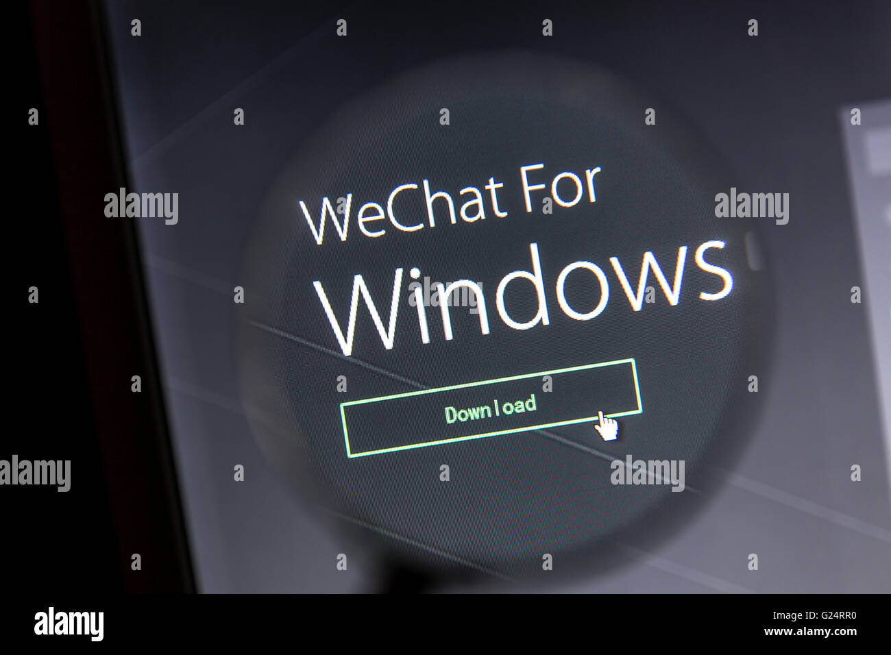 WeChat's website under a magnifying glass. WeChat is a famous instant messaging app for smartphones Stock Photo
