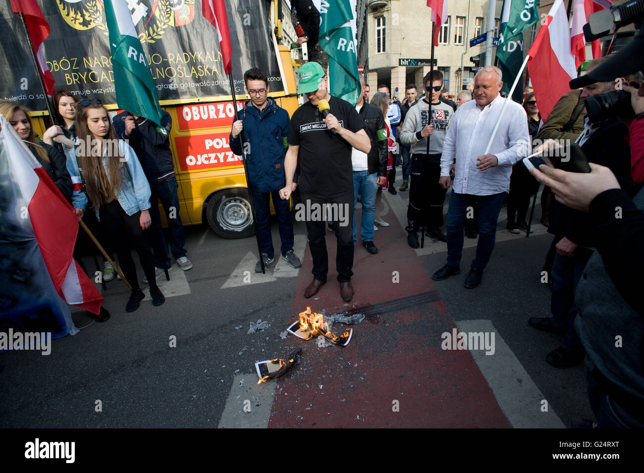 Wroclaw, Poland. 1st May, 2016. Roman Zielinski burns picture of Rafal Dutkiewicz during ONR protest in Wroclaw. Stock Photo