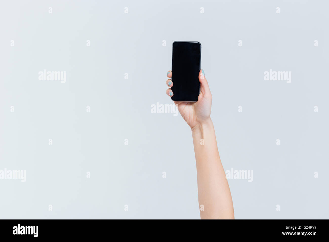 Female hand holding smartphone with blank screen isolated on a white ...