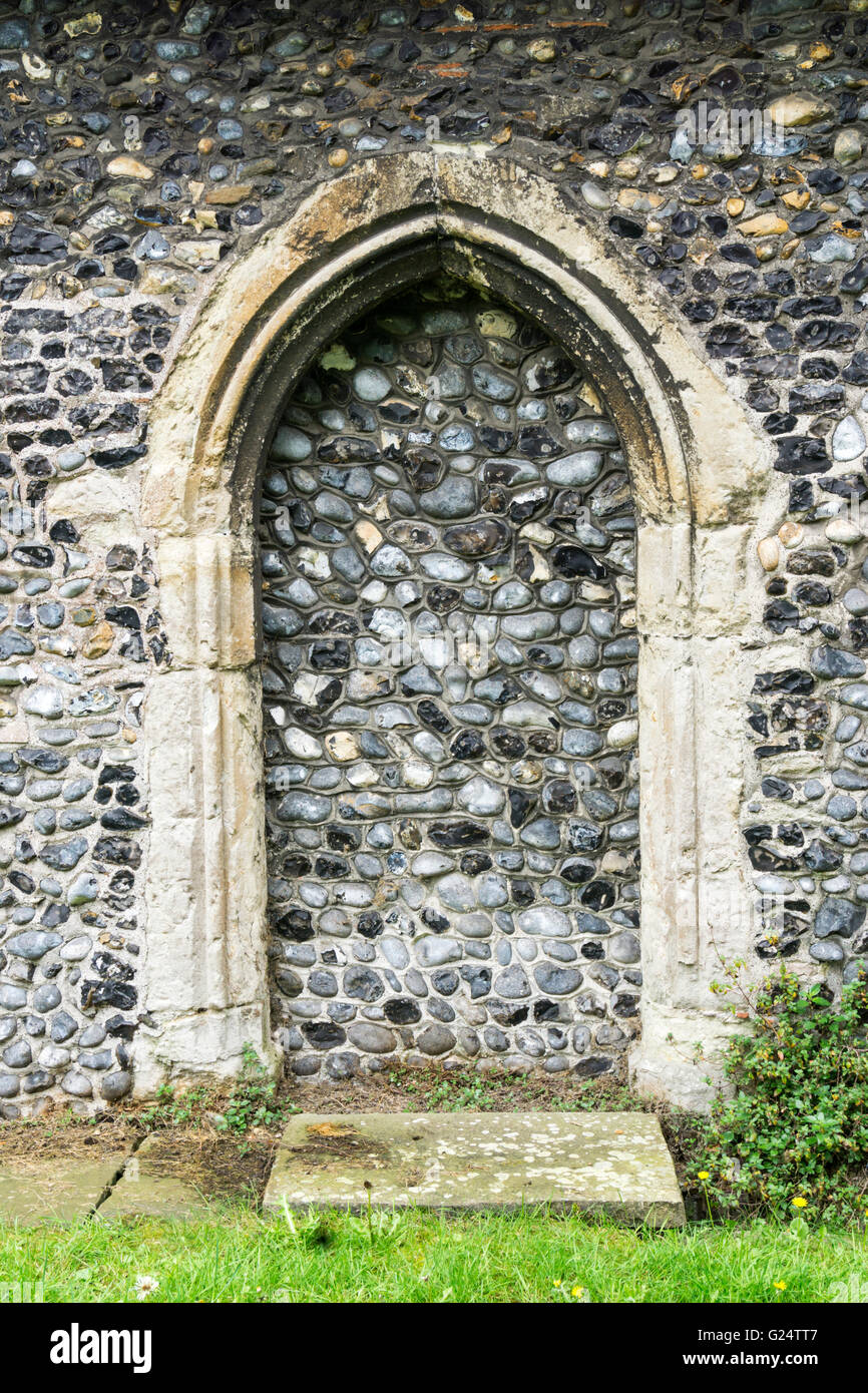 An old blocked archway in the wall of All Saints Church at Birchington in Kent. Stock Photo