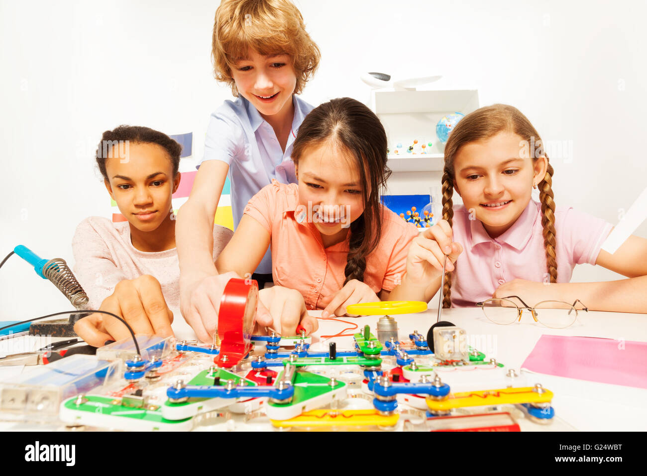 Four teenage students making a physical test Stock Photo