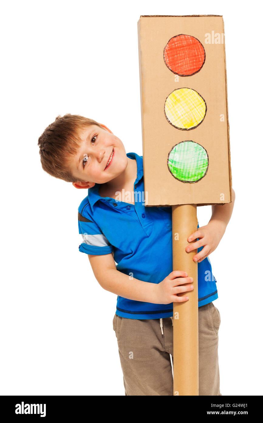Smiling boy emerging from behind cardboard lights Stock Photo