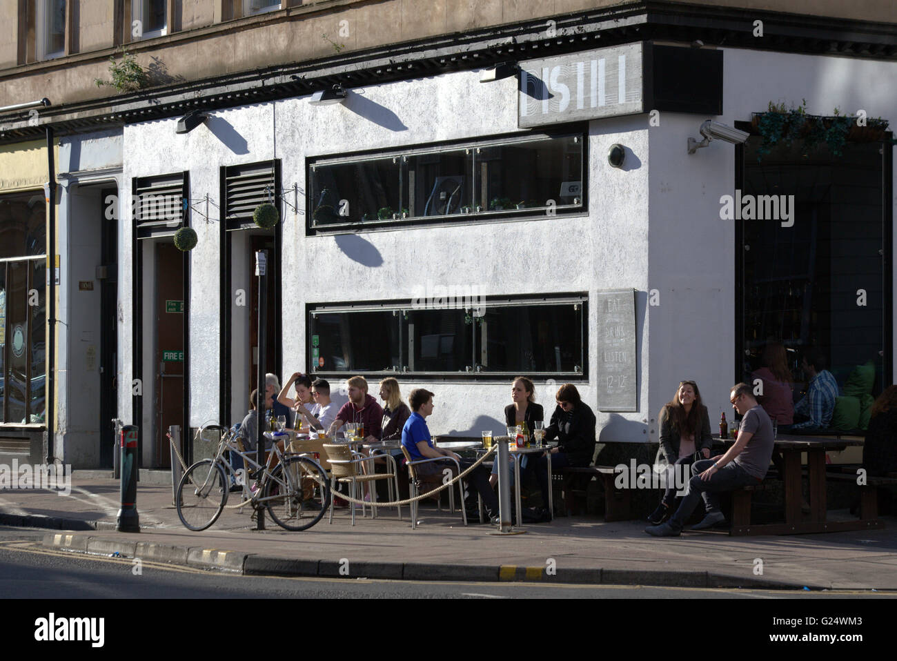 Men  and women enjoying a drink with mobile phones Finnieston, Glasgow, Scotland, UK. Stock Photo