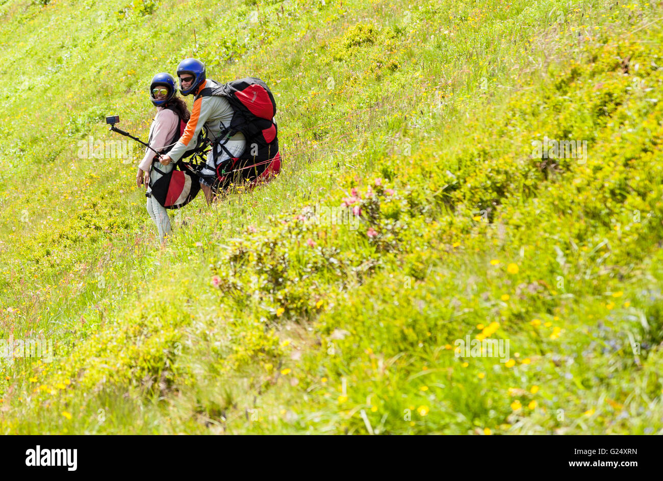 two people about to set off paragliding taking a selfie on top of the Schmitten mountain or Schmittenhohe Zell am See Austria Stock Photo