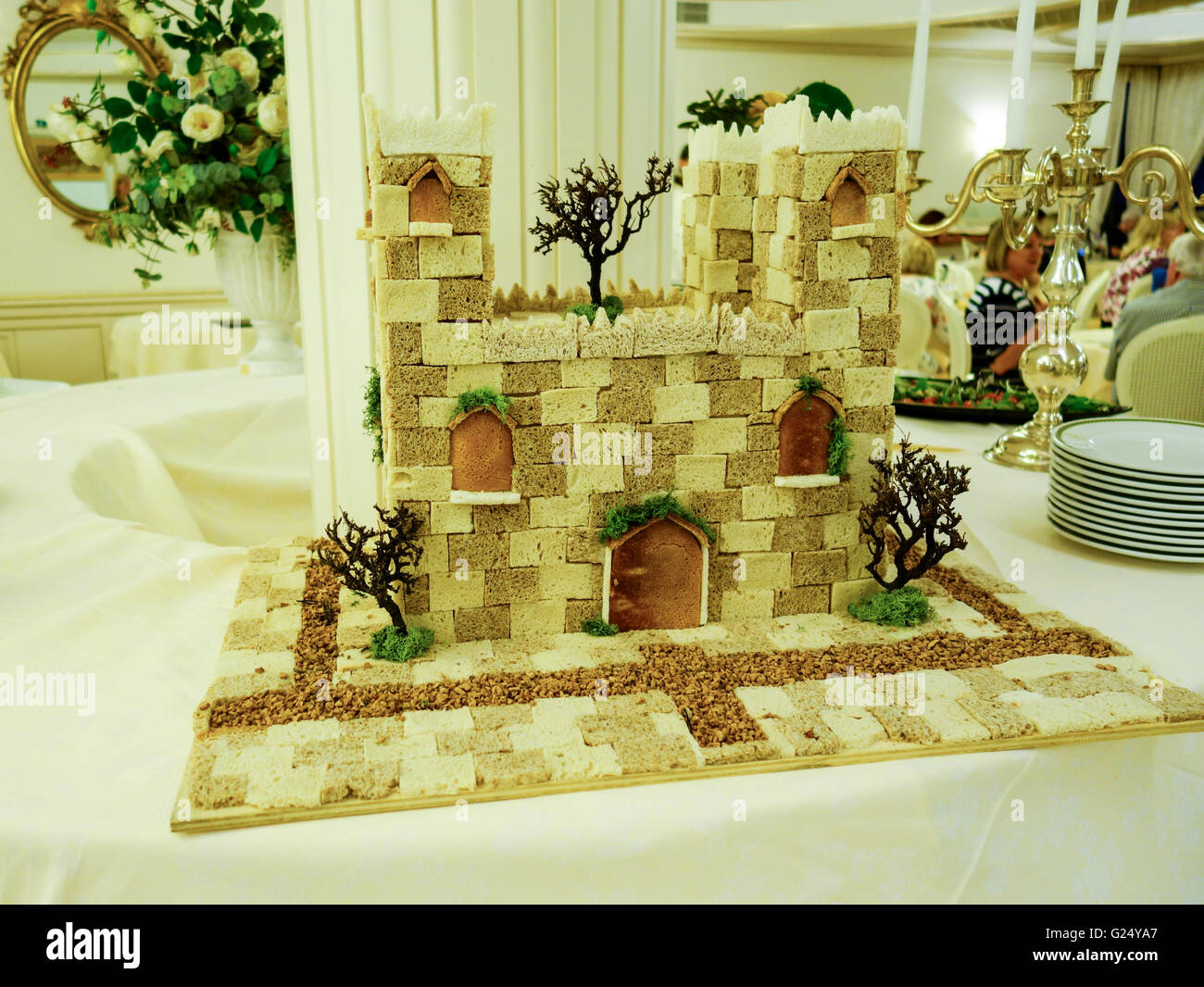 A decorative castle made from different types of bread on a table in a hotel dinning room Stock Photo