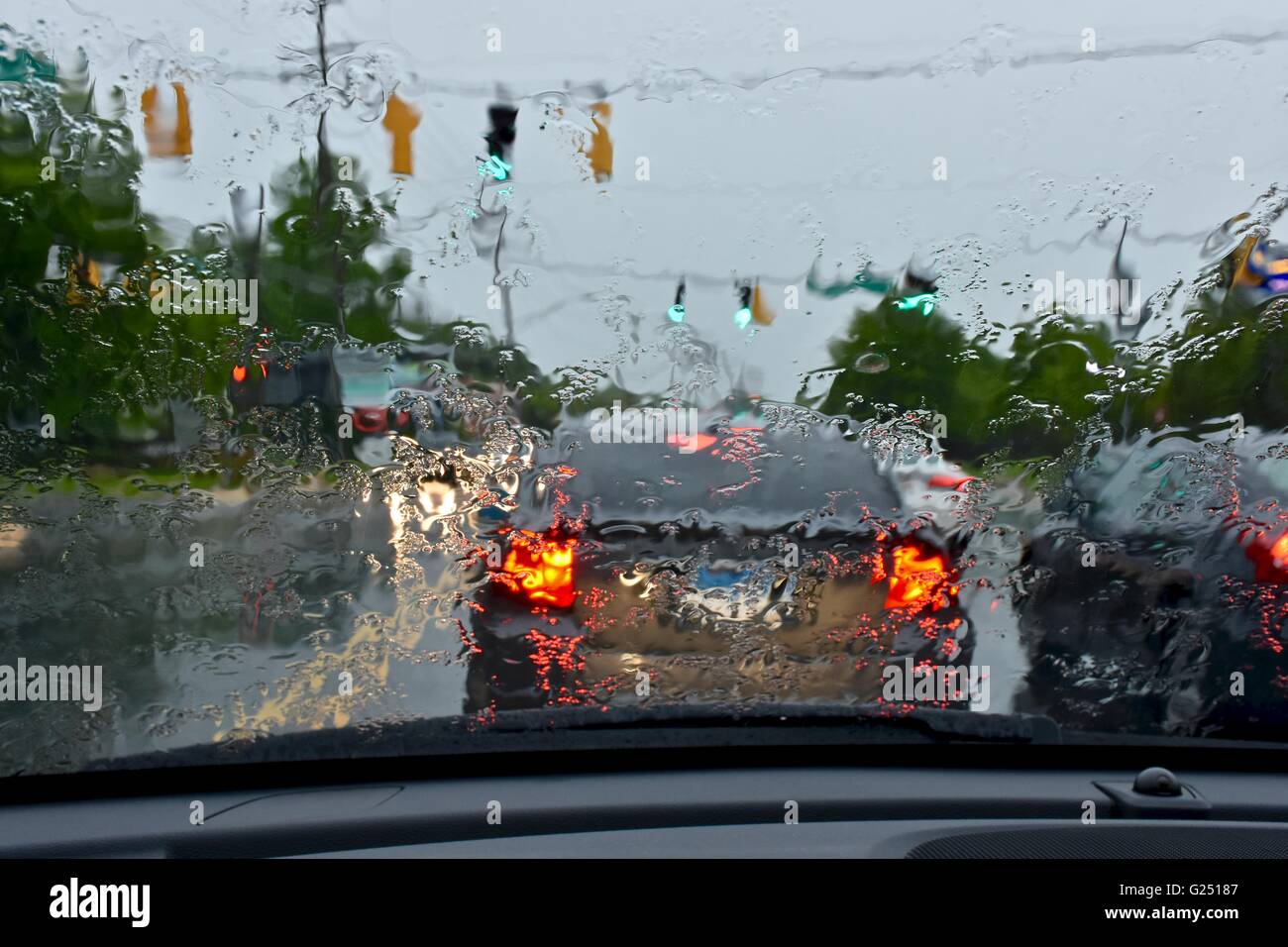 Driving a car during a rainy day, causing unsafe driving conditions Stock Photo