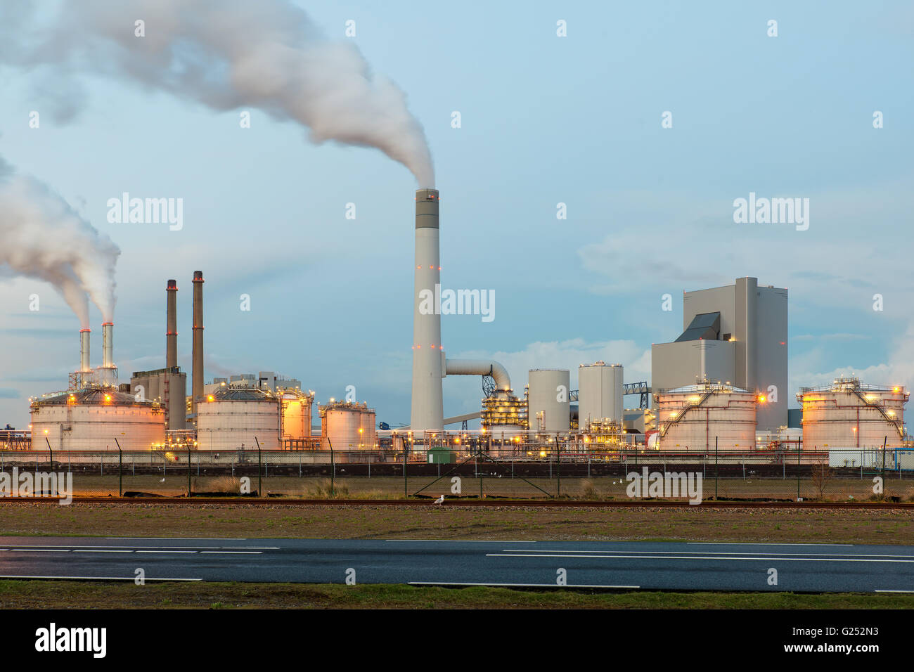 Oil refinery with smoking at twilight Stock Photo